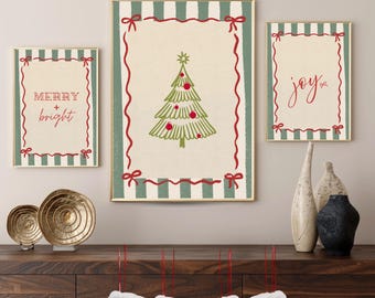 May include: Three framed Christmas art prints. The prints feature a green and white striped border with red ribbon accents. One print says "Merry + Bright", another has a Christmas tree, and the third says "joy".