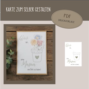 May include: A greeting card with the text "Glück ist... eine Mama wie Dich zu haben!" and a drawing of flowers in a pot. The card has a light brown border and is on a wooden surface. The words "Karte zum selber gestalten" and "PDF Druckvorlage" are also visible.