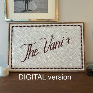 May include: A rectangular mosaic wall art piece framed in wood, featuring a white background of small square tiles arranged in a fan pattern. The text "The Vani's" is spelled out in dark red tiles in a cursive script, bordered by a dark red tile frame.