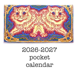 May include: A pocket calendar featuring a symmetrical illustration of two cats with orange fur, blue eyes, and a smiling expression. The background has a blue and gold design. The text "2026-2027 pocket calendar" is below the illustration.