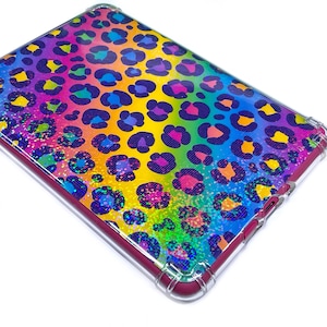 May include: A rectangular tablet case with a vibrant rainbow leopard print design. The case features a clear, protective border and a maroon-colored frame. The leopard spots are in shades of purple, blue, yellow, orange, and pink.