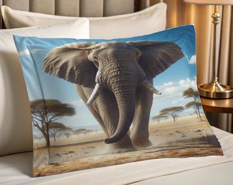 May include: A pillowcase featuring a detailed illustration of an African elephant charging forward. The elephant is gray with large ears and tusks, set against a backdrop of a savanna landscape with trees and a blue sky.