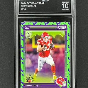 May include: A green, purple, and white football card featuring Travis Kelce, a tight end for the Kansas City Chiefs. The card is graded Gem Mint 10 by Dylan's and has the text "2024 Score-A-Treat" and "#136".