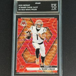 May include: A graded sports trading card featuring Ja'Marr Chase in a Bengals uniform. The card is a 2025 Mosaic #11 Red Wave Prizm, graded GEM MINT 10. The card has a red mosaic background and the text "JA'MARR CHASE" is visible.