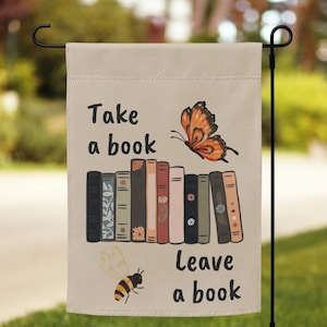 May include: A beige garden flag with the text "Take a book, Leave a book" and a stack of books with a butterfly and a bee illustration.