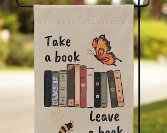 May include: A beige garden flag with the text "Take a book, Leave a book" and a stack of books with a butterfly and a bee illustration.
