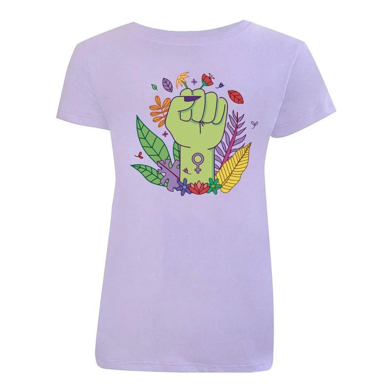 K&ouml;nnte beinhalten: Ein hellviolettes T-Shirt mit einer erhobenen gr&uuml;nen Faust. Die Faust h&auml;lt eine Blume und hat ein weibliches Symbol am Handgelenk. Die Faust ist von bunten Blumen und Bl&auml;ttern umgeben.