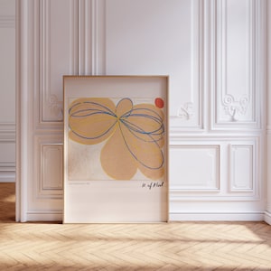 May include: A framed abstract art print featuring a yellow, blue, and red colour scheme. The print depicts a large, organic shape with overlapping lines and a small red circle in the top right corner. The artist's signature and the title "H. of Plant" are visible at the bottom of the print.