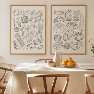 May include: Two framed black and white illustrations of food. The left illustration shows a variety of pasta shapes. The right illustration shows a variety of bread shapes.
