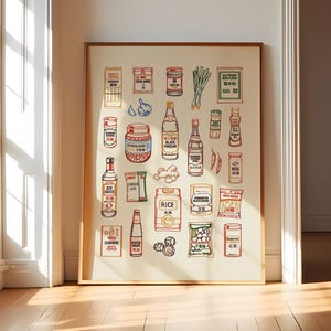 May include: A framed wall art print on a light cream background featuring a collection of colorful line-art illustrations of various Asian pantry staples, including bottles of soy sauce, black vinegar, oyster sauce, rice, and bags of spices.
