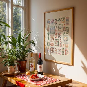 May include: A dining room scene featuring a wooden table with a red and white patterned runner. A framed print of illustrated food items hangs on the wall. Two bottles of wine, a bowl of tomatoes, and potted plants are on the table.
