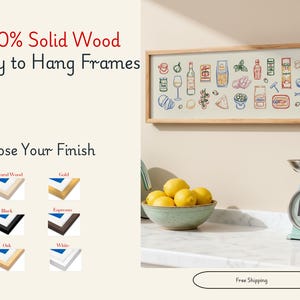 May include: A framed print with a light wood finish, featuring colorful illustrations of food items. The text "100% Solid Wood Ready to Hang Frames" is at the top. Below, options for frame finishes are shown: Natural Wood, Gold, Black, Espresso, Oak, and White.