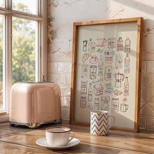 May include: A framed wall art print featuring a collection of colorful line-art illustrations of coffee-related items, including a moka pot, croissant, milk cartons, syrups, and coffee beans, displayed on a wooden surface next to a pink toaster.