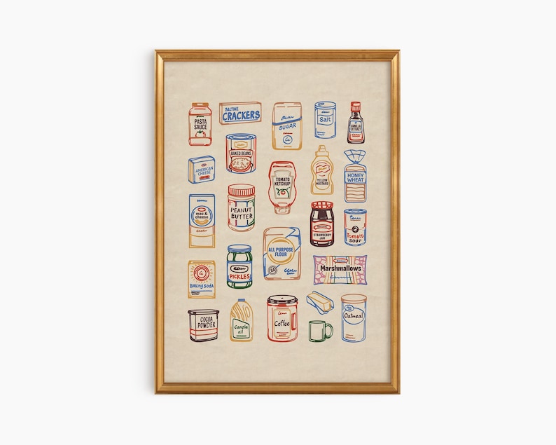 May include: A framed print featuring a collection of illustrated pantry staples. The artwork includes colorful depictions of various food items such as pasta sauce, crackers, peanut butter, and coffee. The print is in a gold frame.