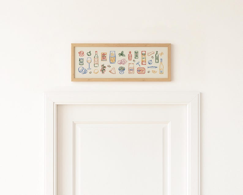 May include: A framed artwork featuring colorful line drawings of various food and drink items. The illustrations include bottles, glasses, and packaged goods, all set against a neutral background within a light wood frame. The artwork is hanging above a white door.