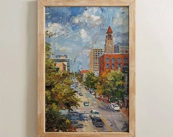 May include: A framed painting of a city street scene with a tall building with a clock tower in the background. The street is lined with trees and cars. The sky is blue with white clouds.