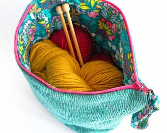 Turquoise Zipper Pouch: Zip top storage bag with floral fabric lining.