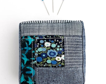 Blue Patchwork Pincushion: Unique handmade pin cushion made from a variety of blue fabrics.