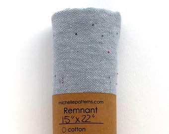 Essex Speckle in Chambray: REMNANT of light blue fabric with colorful flecks.