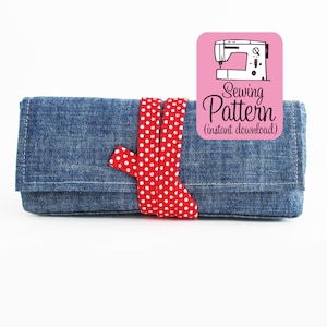 May include: A denim blue fabric pencil case with a red and white polka dot ribbon tied around it. The case is closed and the ribbon is tied in a bow. A pink label with a sewing machine graphic and the text "Sewing Pattern (instant download)" is in the upper right corner of the image.