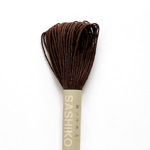 May include: A spool of brown sashiko thread with a label that reads "Sashiko" and "刺し子糸 -20m".