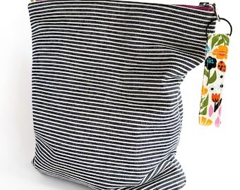 Striped Denim Zipper Pouch: Zip top storage bag with floral fabric lining.