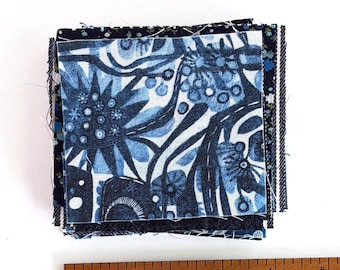 Mending Bits: Small pieces of natural fiber fabrics in shades of blue.