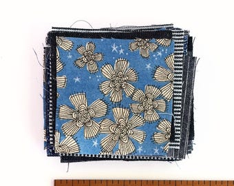 Mending Bits: Small pieces of natural fiber fabrics in shades of blue.