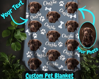 May include: A custom pet blanket with a blue background and a repeating pattern of a dog's face, paw prints, and the name "Charlie".