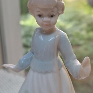 Vintage porcelain figurine of girl w/ponytail and dog / so cute! / Polka dots on dress and girl playfully posed
