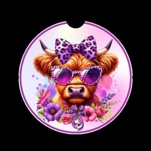 May include: A Highland cow with a purple and white spotted bow, wearing pink sunglasses and surrounded by purple, pink, and white flowers.