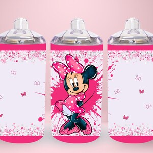 May include: A pink and white sippy cup featuring a cartoon Minnie Mouse design. The cup has a clear handle and a clear top. The design includes pink splatters, butterflies, and a pink bow. The cup is designed for toddlers.