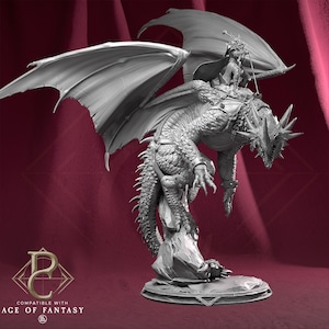 May include: A detailed grayscale figurine of a dragon with a rider. The dragon has large wings, a spiky head, and is mounted on a rocky base. The rider is wearing armor and holding a sword. The base has the text "COMPATIBLE WITH AGE OF FANTASY".