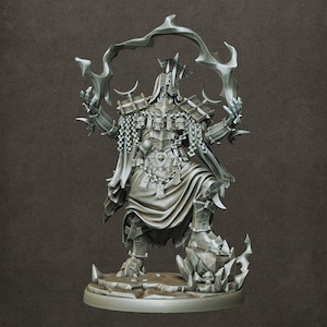 May include: A detailed, gray figurine of a warrior in ornate armor, holding stylized, curved blades. The figure is adorned with skull accents and chains, standing on a rocky base with skull details. The warrior wears a helmet and a flowing cape.