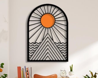 May include: Black metal wall art featuring a geometric design of a sun, mountains, and waves. The sun is orange and the background is white.