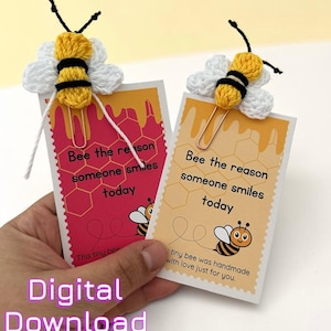 May include: Two handmade bee-themed paper clips with attached cards. The cards have the text "Bee the reason someone smiles today" and a cartoon bee illustration. The bee paper clips are yellow, black, and white.