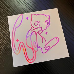 May include: A holographic sticker featuring a cartoon-style illustration of Mew, a Pok&eacute;mon character. The design uses a gradient of pink, purple, and orange. The sticker is square and includes star accents.
