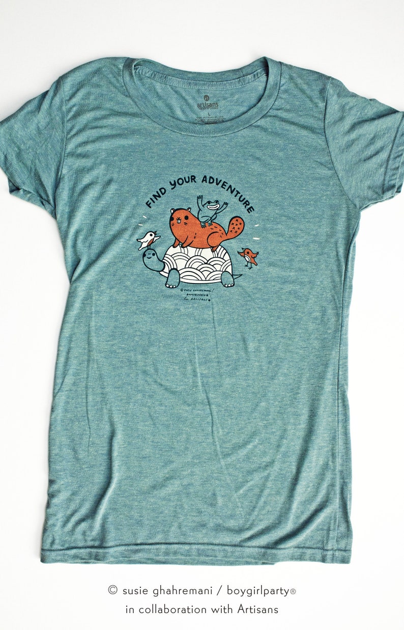 May include: Teal blue t-shirt with a graphic of a turtle, beaver, frog, and birds. The text "Find Your Adventure" is printed on the shirt.