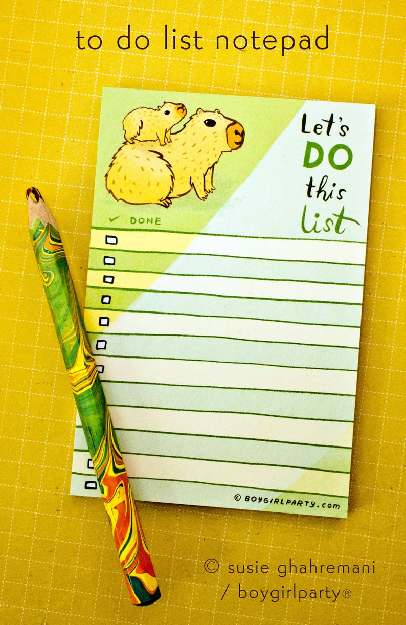 May include: A to-do list notepad with a green and blue striped background. The notepad features a cartoon illustration of two capybaras and the text "Let's DO this list".