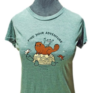 May include: A green t-shirt with the text "Find Your Adventure" printed on the front. The design features a turtle carrying a beaver, a frog, and a bird.