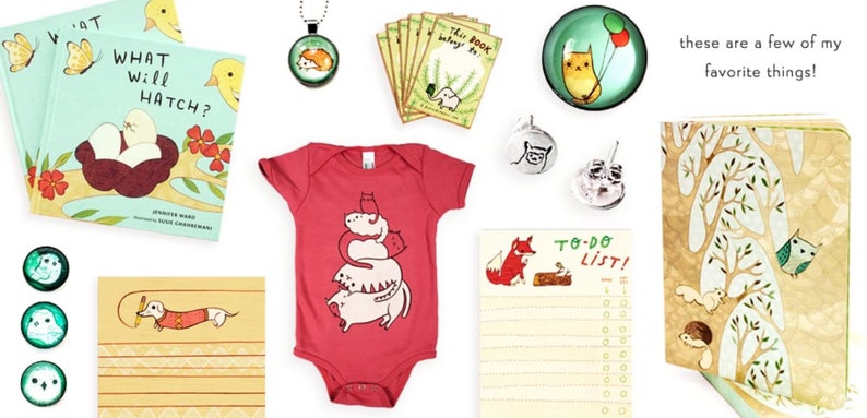 May include: A collection of items featuring cute animal illustrations.  The items include a book titled "What Will Hatch?", a red baby onesie with a stack of cats, a to-do list notepad with a fox, a small notebook with a woodland scene, and several small glass ornaments with animal designs.