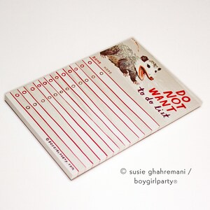 May include: A white notepad with red lines and a cartoon possum illustration. The notepad says "Do Not Want to do list".