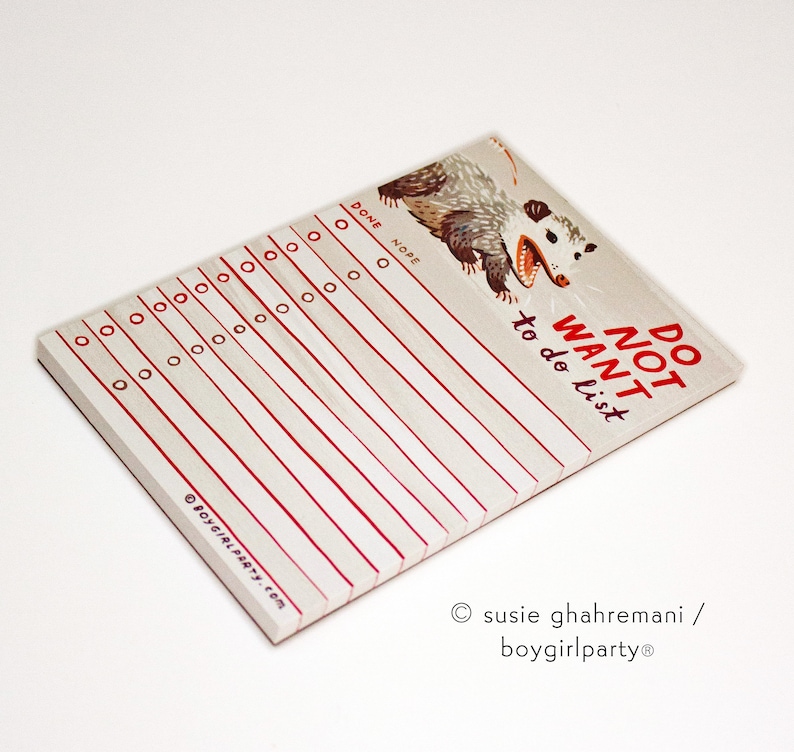 May include: A white notepad with red lines and a cartoon possum illustration. The notepad says "Do Not Want to do list".