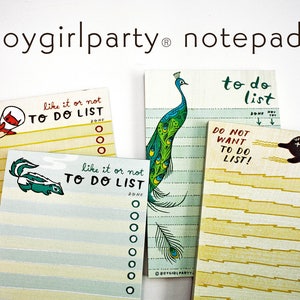May include: Four colorful to-do list notepads with different illustrations. The notepads feature a peacock, a cat, a skunk, and a cat. The notepads have a yellow and blue striped background with a white border. The notepads have the text "like it or not TO DO LIST" and "to do list" printed on them.