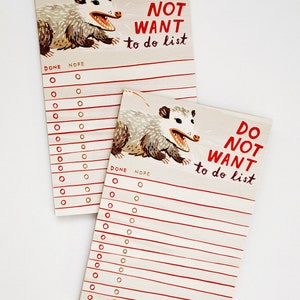 May include: A notepad with two pages featuring a possum illustration and the text "Do Not Want To Do List". The notepad has red lines and gold circles for checking off tasks.