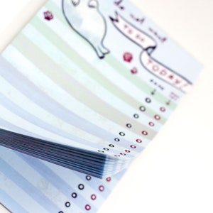 May include: A notepad with a light blue striped design and a cartoon seal illustration. The notepad has a banner that says "do not want to do today!" with check boxes. The notepad is on a white background.