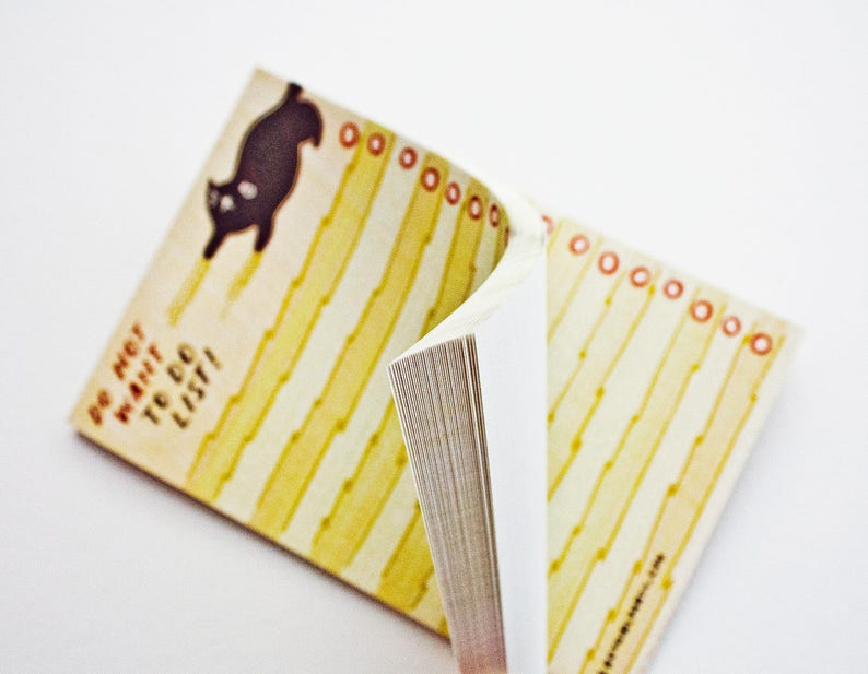May include: A yellow and white to-do list notepad with a black cat illustration and the text "Do not want to do list!"