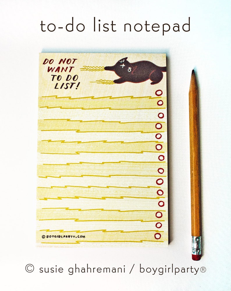 May include: A yellow notepad with a black cat illustration and the text "DO NOT WANT TO DO LIST!"  The notepad has a yellow lightning bolt pattern and red circles along the right edge.