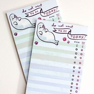 May include: Two notepads with a whimsical design. Each notepad features a cartoon seal, the text "do not want to do today!", and a checklist. The notepads have a striped background in shades of blue and green.