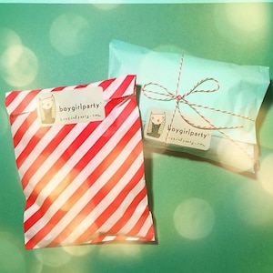 May include: Two gift bags, one red and white striped and one light blue, both with a white sticker that says "boygirlparty boygirlparty.com".
